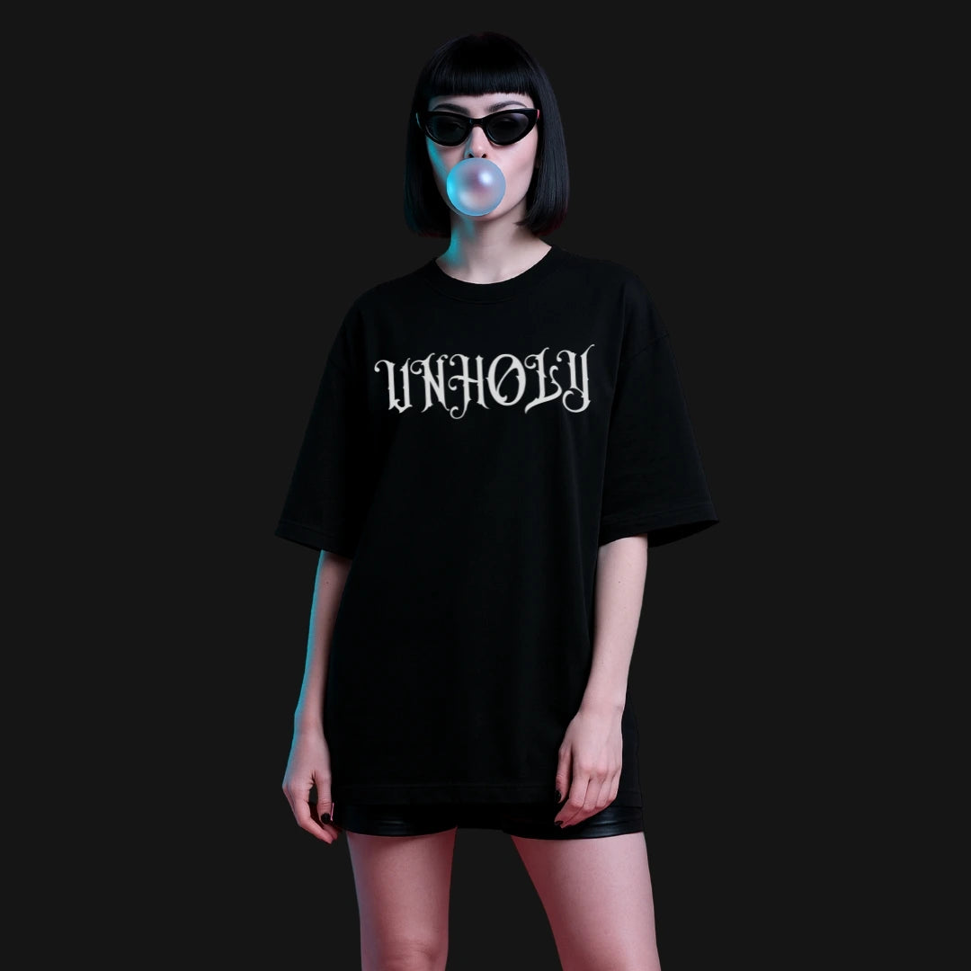 Zenith Lifestyle oversized black T-shirt with unholy print worn by model blowing bubble gum