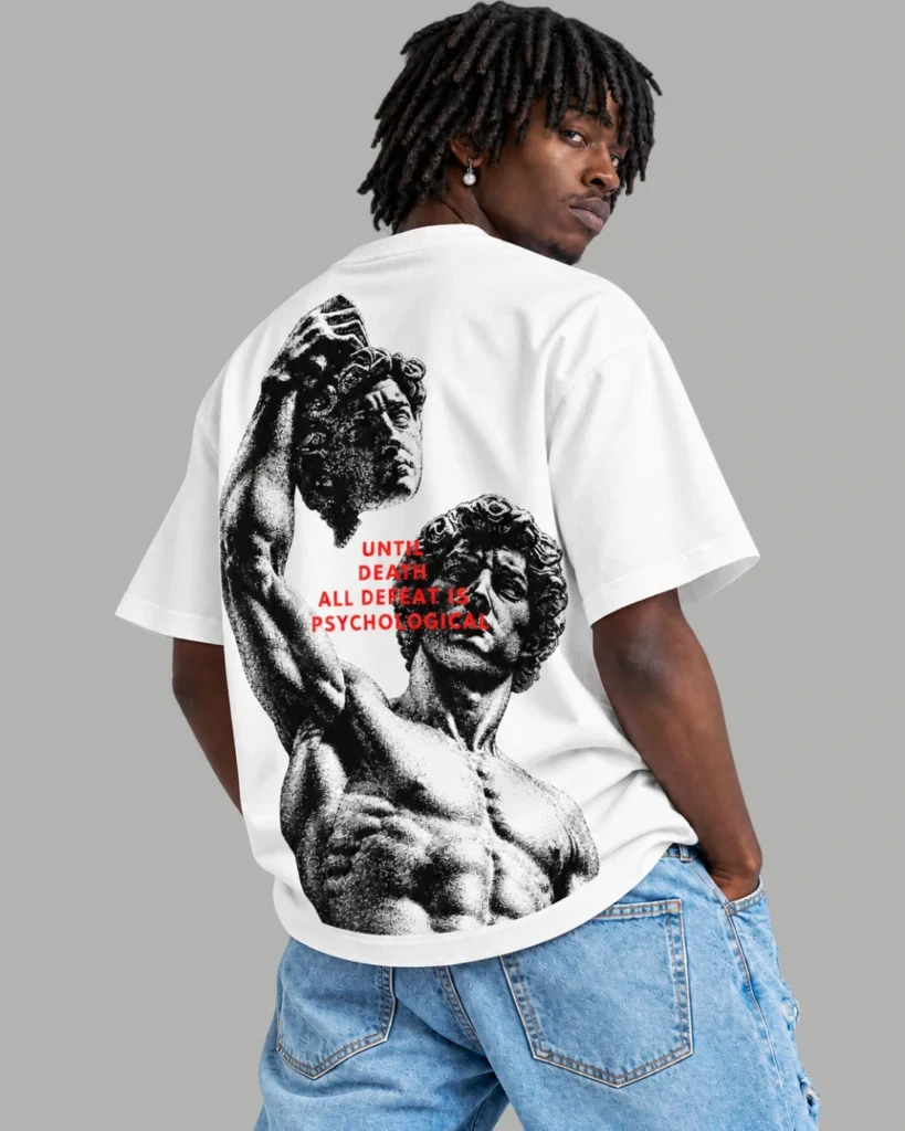 A model wearing a white oversized t-shirt with graphic design named Undefeatable from Zenith Lifestyle